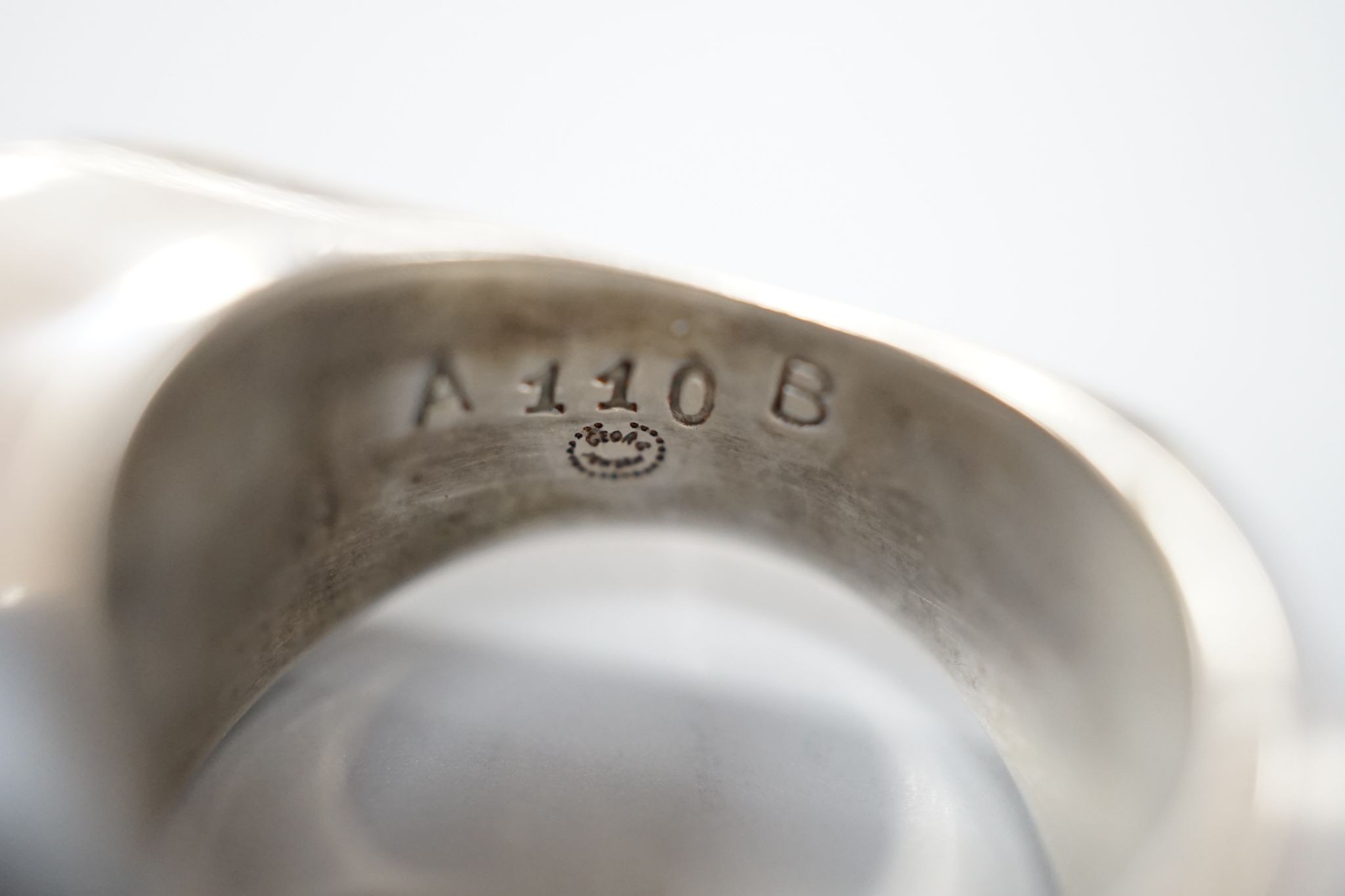 A Georg Jensen sterling ring, no. A11O B, size Q and a Georg Jensen 925 and enamel CX 1870-1940 King Christian drop brooch, 32mm.